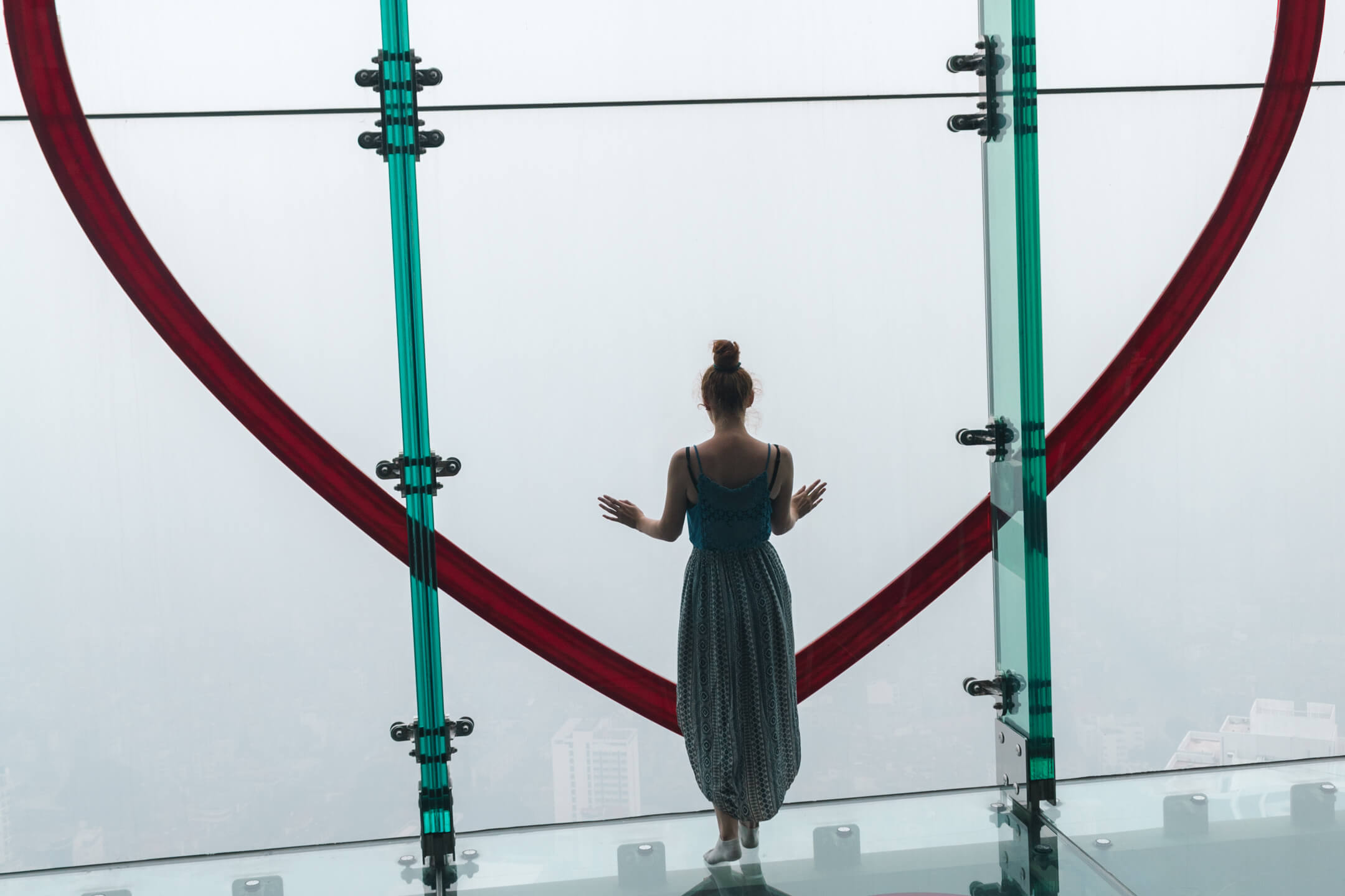 Girl looking out over view from heart photo point in Lotte Tower