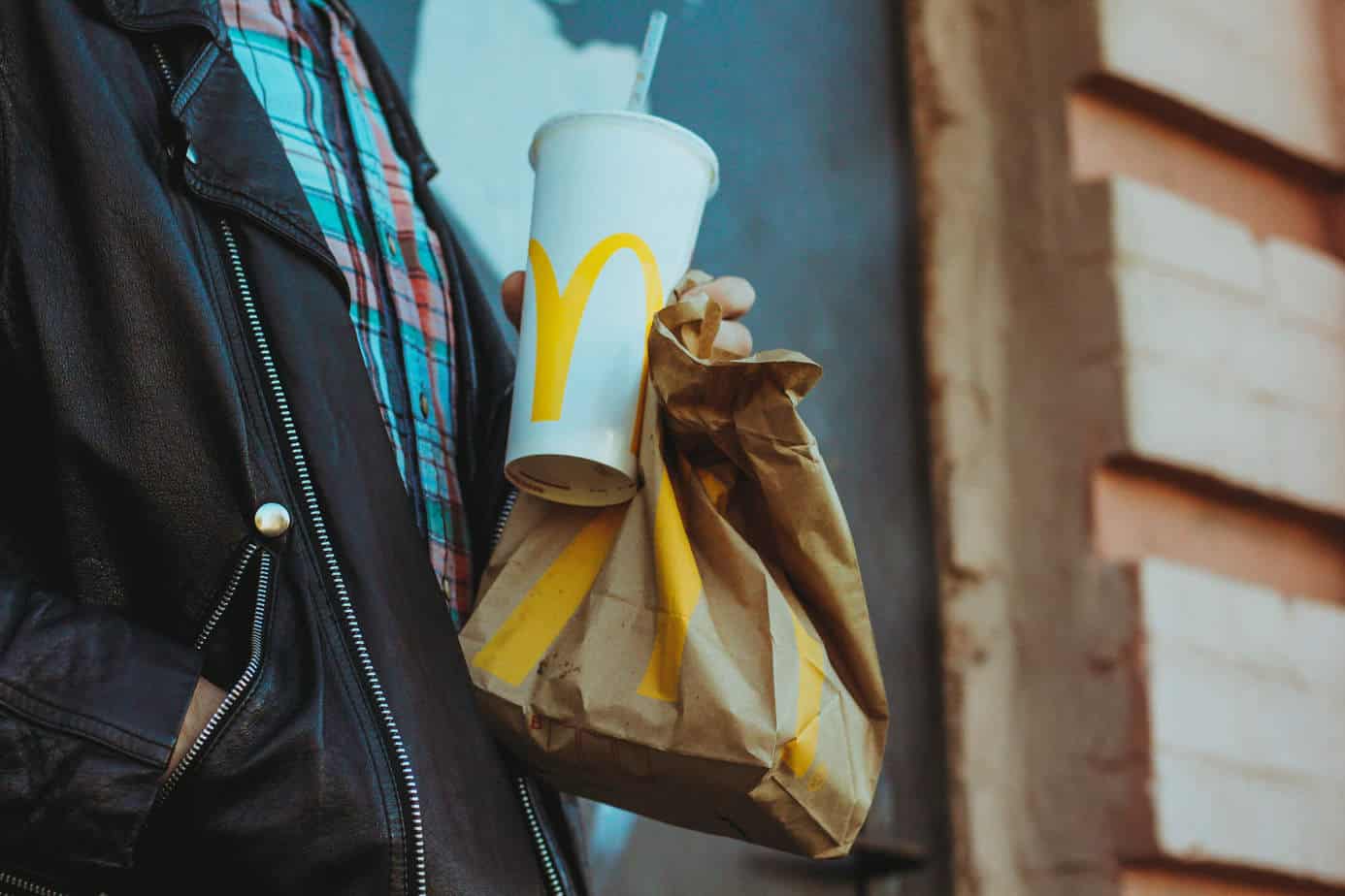 Man holding mcdonalds fast food takeaway