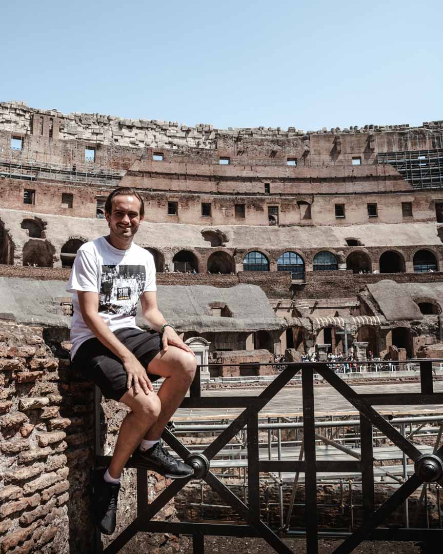 Guy sat in the Colosseum